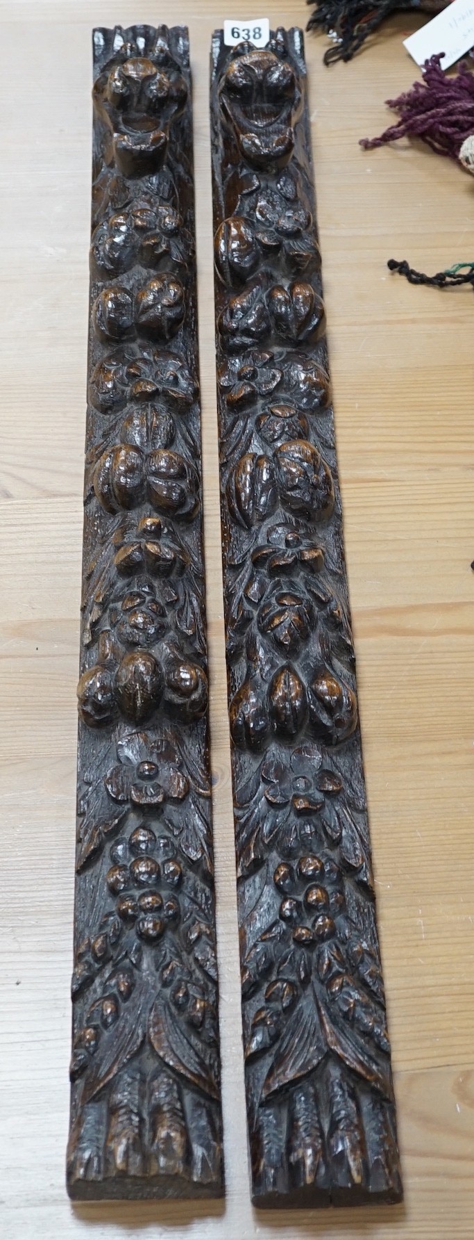 A pair of early carved wood hanging mouldings in the Flemish style, 81cm tall